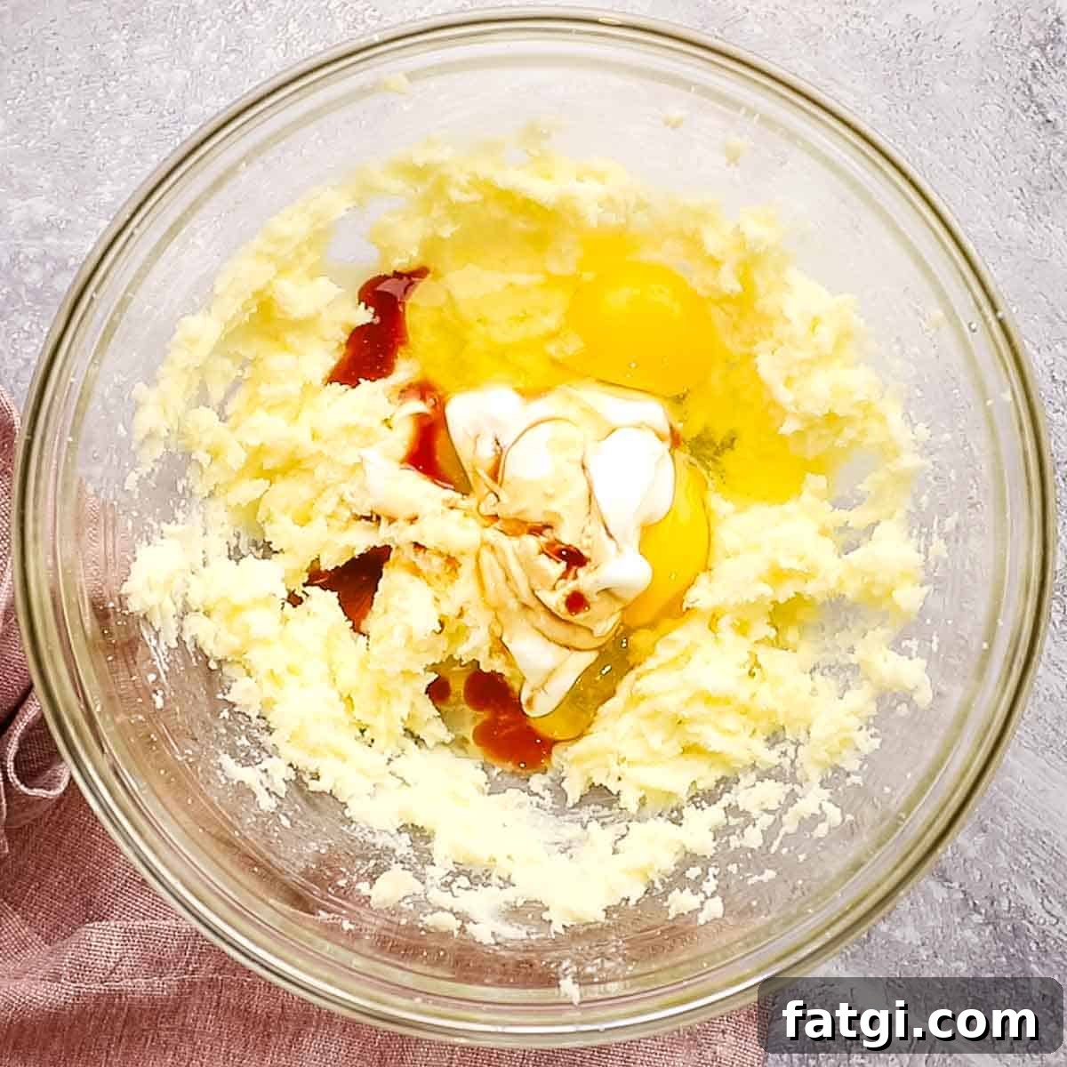 eggs, sour cream, and vanilla added to the creamed butter and sugar