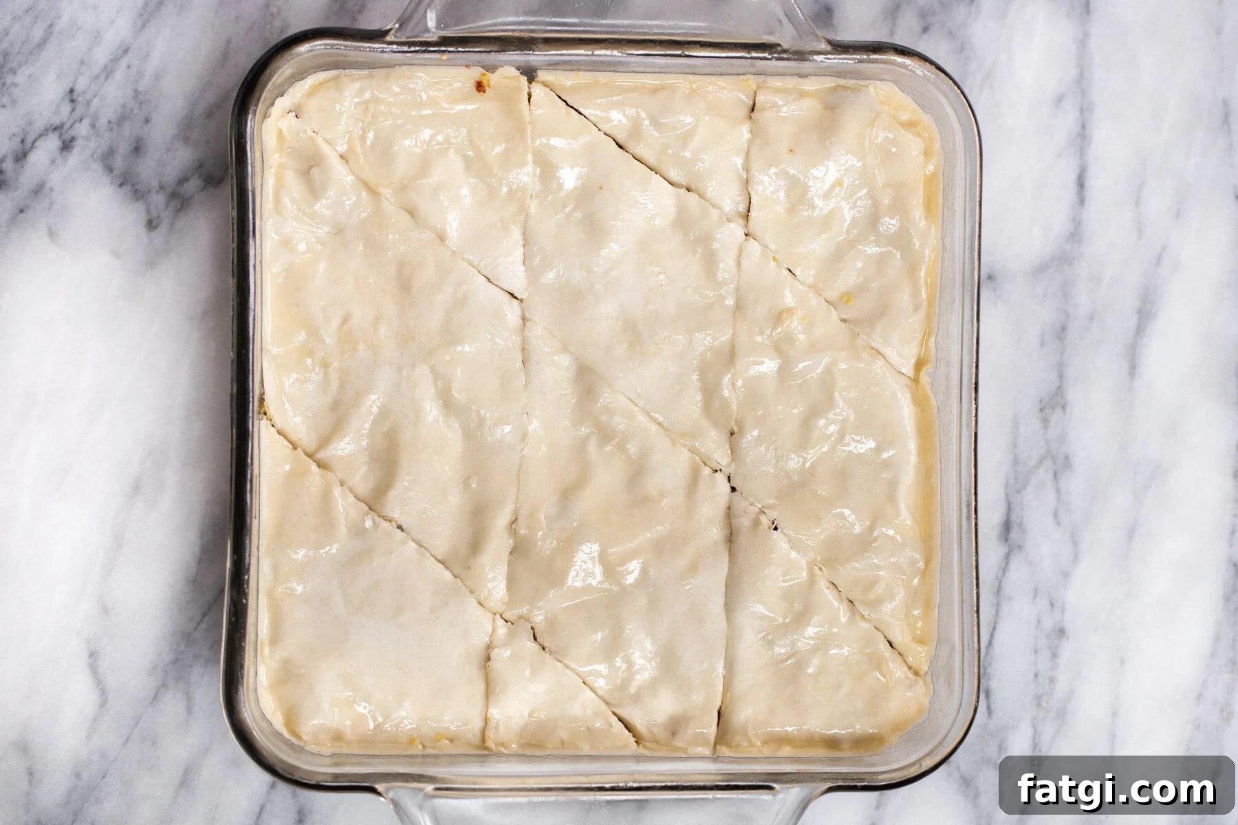 Vegan Baklava with Date and Nut Filling 14 vegan baklava unbaked in a glass casserole dish