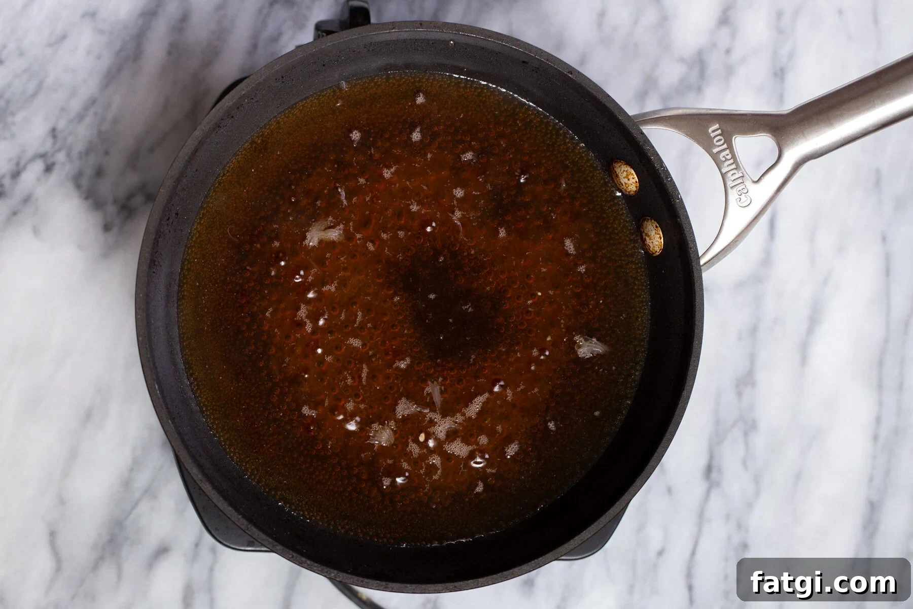 Vegan Baklava with Date and Nut Filling 16 baklava soaking syrup in a black saucepan