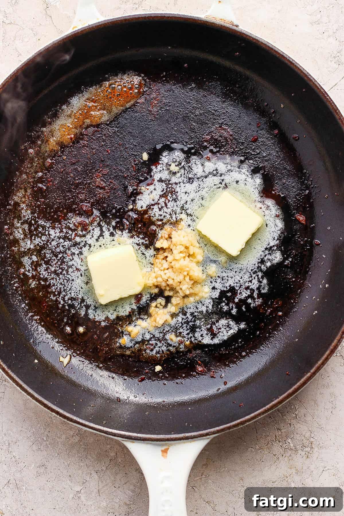 Garlic Butter Steak Bites Recipe 6 Steak removed from the pan and butter and garlic added.