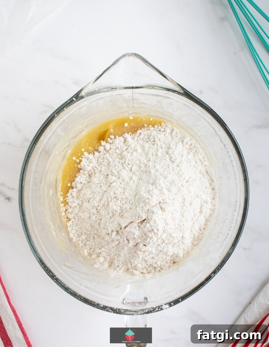 Candy Cane Cream Cheese Cookies, add wet and dry ingredients to bowl