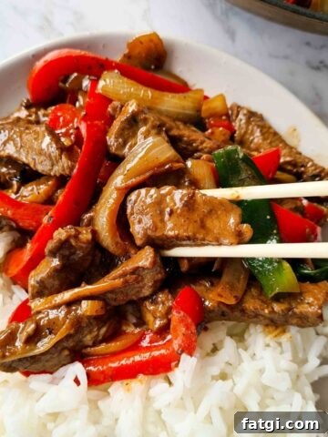 A plate of beef with black bean stir fry with rice