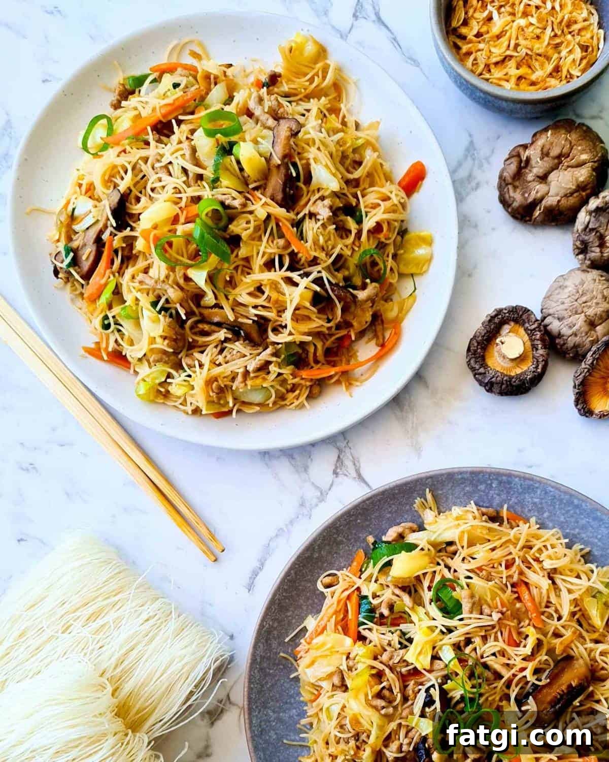 Two serving plates of tsao mi fun Taiwanese vermicelli stir fry