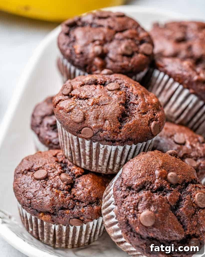 side shot of healthy chocolate muffins on a white plate