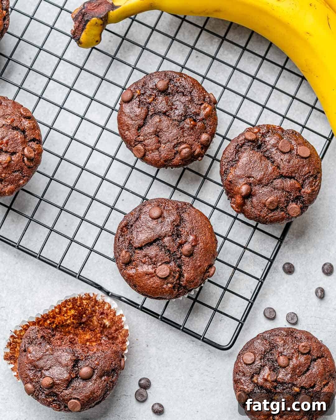 Chocolate peanut butter banana muffins on cooling rack with some wrappers removed