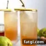 two sparkling bourbon pear cocktails with pear garnishes