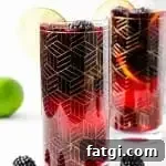 two gold etched glasses of blackberry sangria