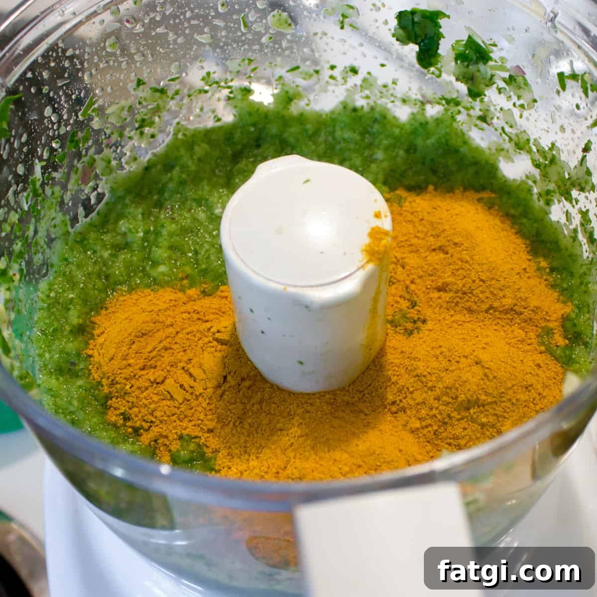 Curry powder dumped into the food processor with blended paste.