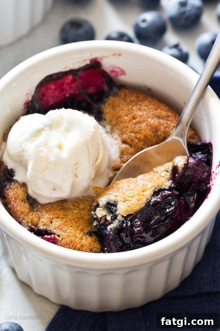 Mini Blueberry Cobbler for Two 4 Close up of spoon serving blueberry cobbler