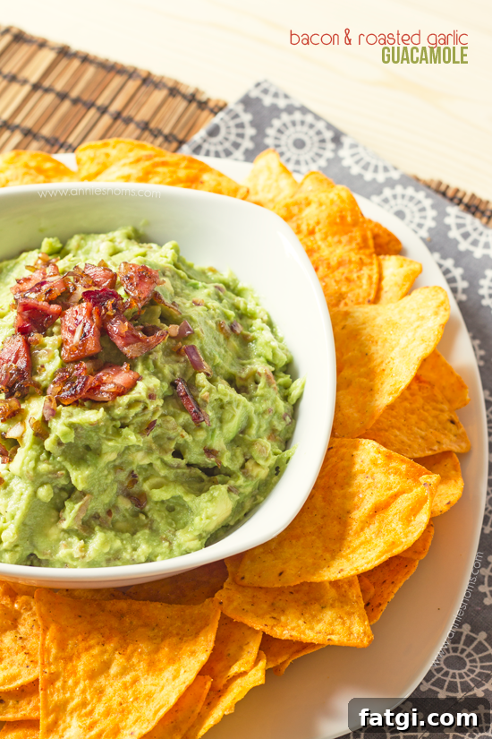 Bacon and Roasted Garlic Guacamole - This is no normal guacamole! This mind-blowing homemade guacamole has roasted garlic, bacon and fried onions in! Served with tortilla chips, this will be one appetizer you won't want to share!