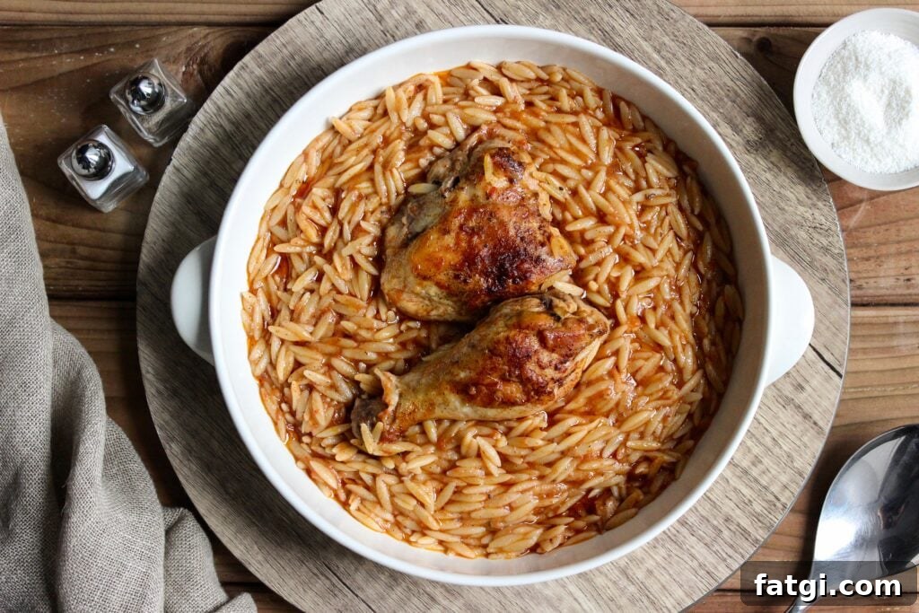 Youvetsi with chicken in pure comfort food. Tender chicken and wonderful orzo baked in a rich tomato based sauce.