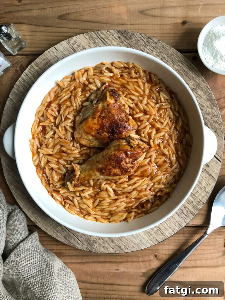 Youvetsi with chicken in pure comfort food. Tender chicken and wonderful orzo baked in a rich tomato based sauce.