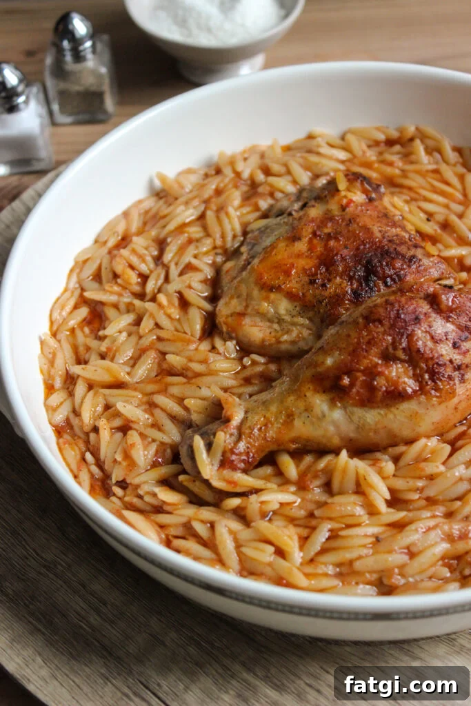 Youvetsi with chicken in pure comfort food. Tender chicken and wonderful orzo baked in a rich tomato based sauce.