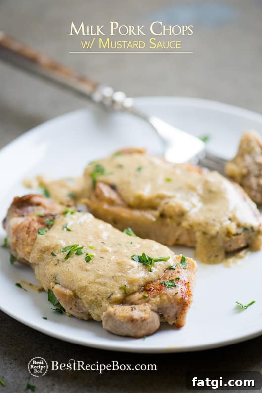 Juicy Pork Chops Braised in Milk with Mustard Sauce Juicy Pork Chops Braised in Milk with Mustard Sauce on a plate with fork