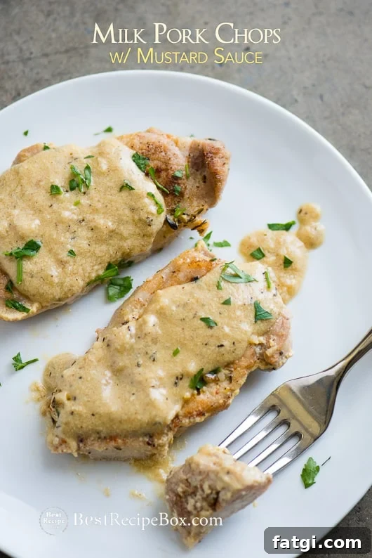 Juicy Pork Chops Braised in Milk with Mustard Sauce Skillet recipe on plate