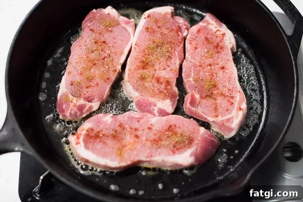 Juicy Milk Braised Pork Chops with Mustard Sauce 5 Pork chops being seared in a skillet