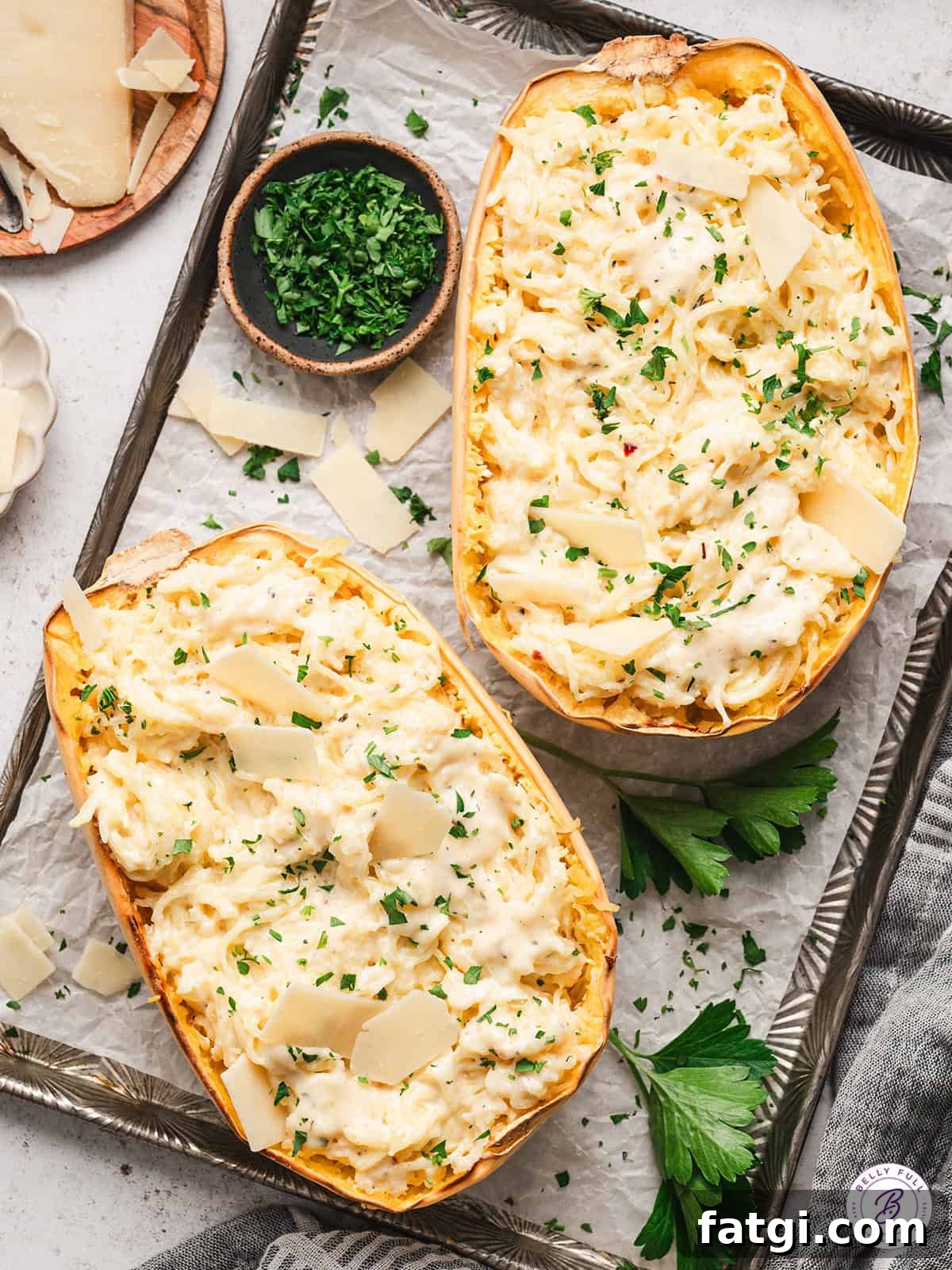 Spaghetti Squash Alfredo with Creamy Garlic Parmesan Sauce 2 2 halves of spaghetti squash alfredo on baking sheet, garnished with parsley