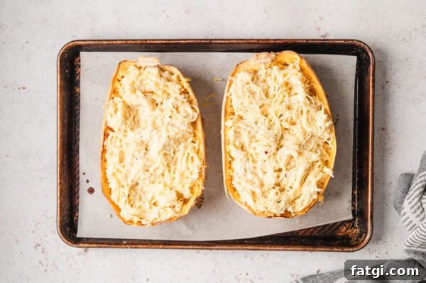 Spaghetti Squash Alfredo with Creamy Garlic Parmesan Sauce 11 2 roasted halves of spaghetti squash stuffed with alfredo sauce on baking sheet