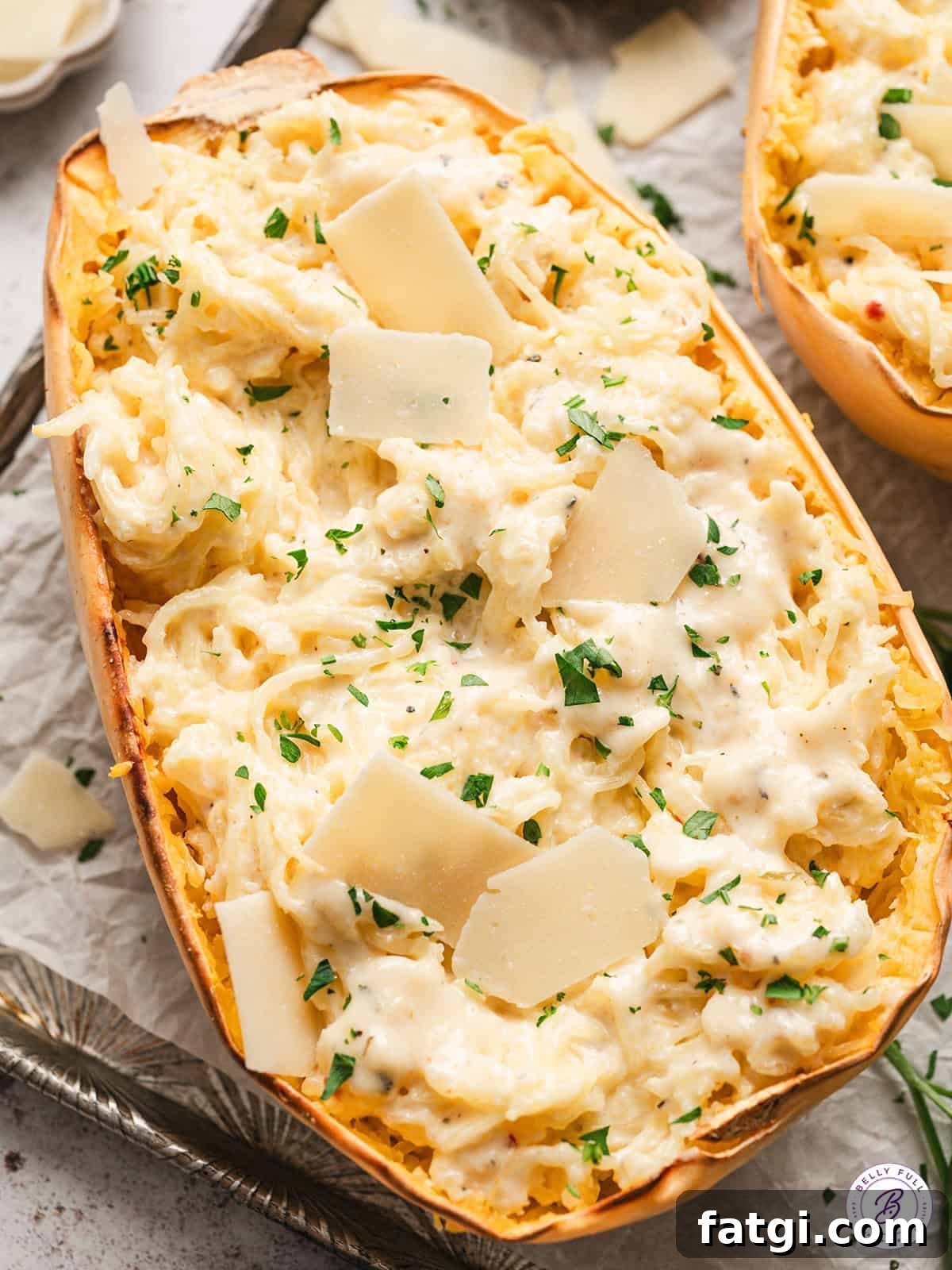 Spaghetti Squash Alfredo with Creamy Garlic Parmesan Sauce 4 half of a roasted spaghetti squash mixed with alfredo sauce, garnished with parsley