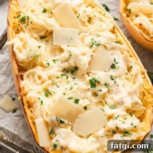 Spaghetti Squash Alfredo with Creamy Garlic Parmesan Sauce 5 half of a roasted spaghetti squash mixed with alfredo sauce, garnished with parsley