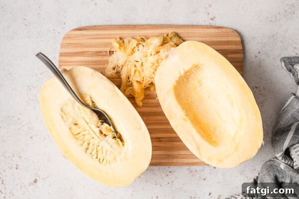 Spaghetti Squash Alfredo with Creamy Garlic Parmesan Sauce 6 2 raw halves of spaghetti squash with seeds removed on cutting board