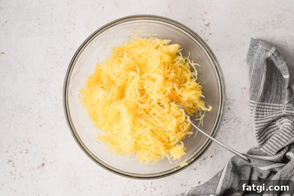 Spaghetti Squash Alfredo with Creamy Garlic Parmesan Sauce 8 roasted spaghetti squash strands in bowl with fork