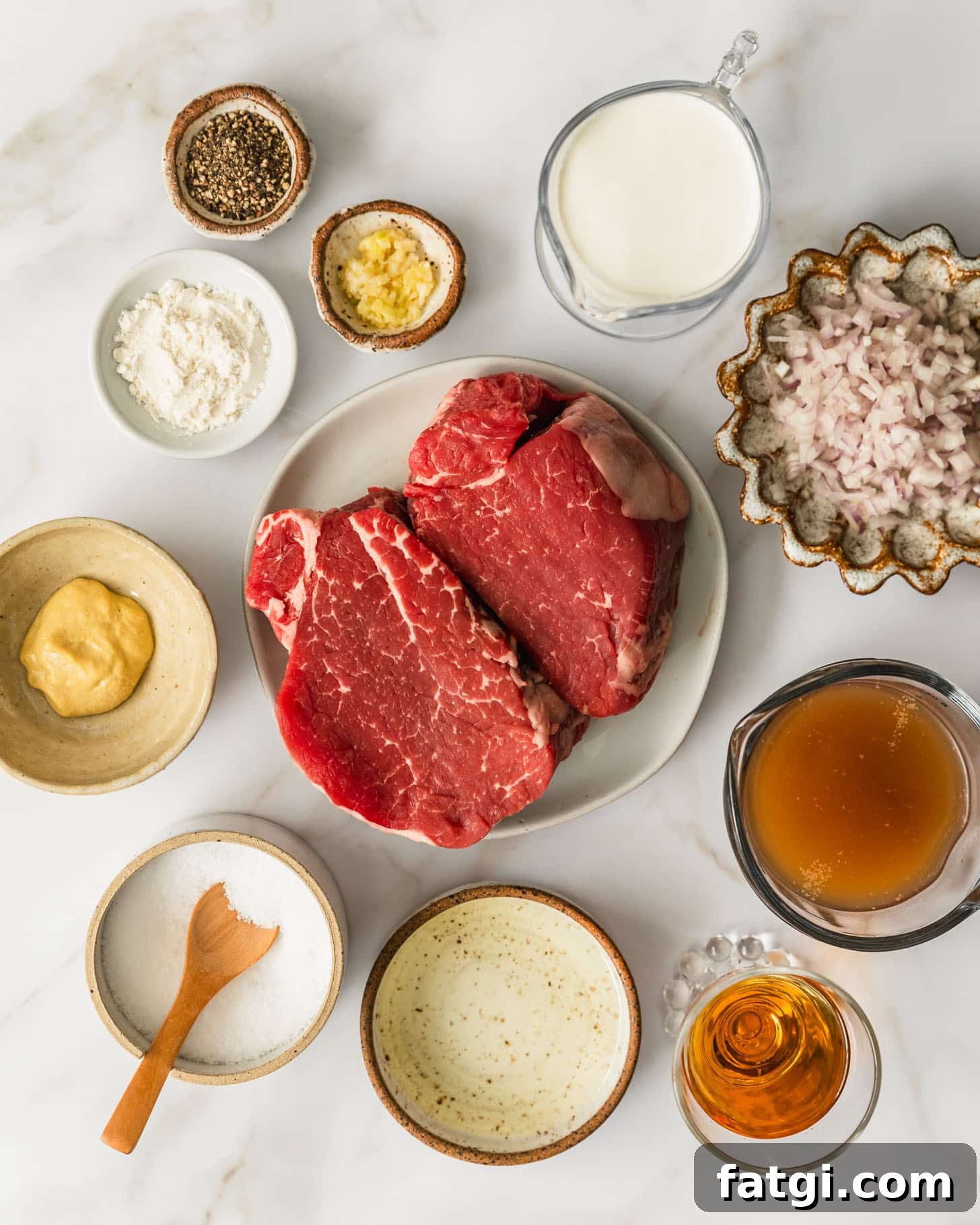 Reverse-Seared Filet Mignon with Creamy Peppercorn Sauce 3 White and brown plates of steak, shallots, cream, garlic, pepper, flour, mustard, salt, oil, brandy, and beef broth on a beige marble counter.