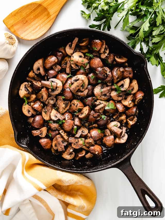Top down view of seasoned mushrooms in a pan.