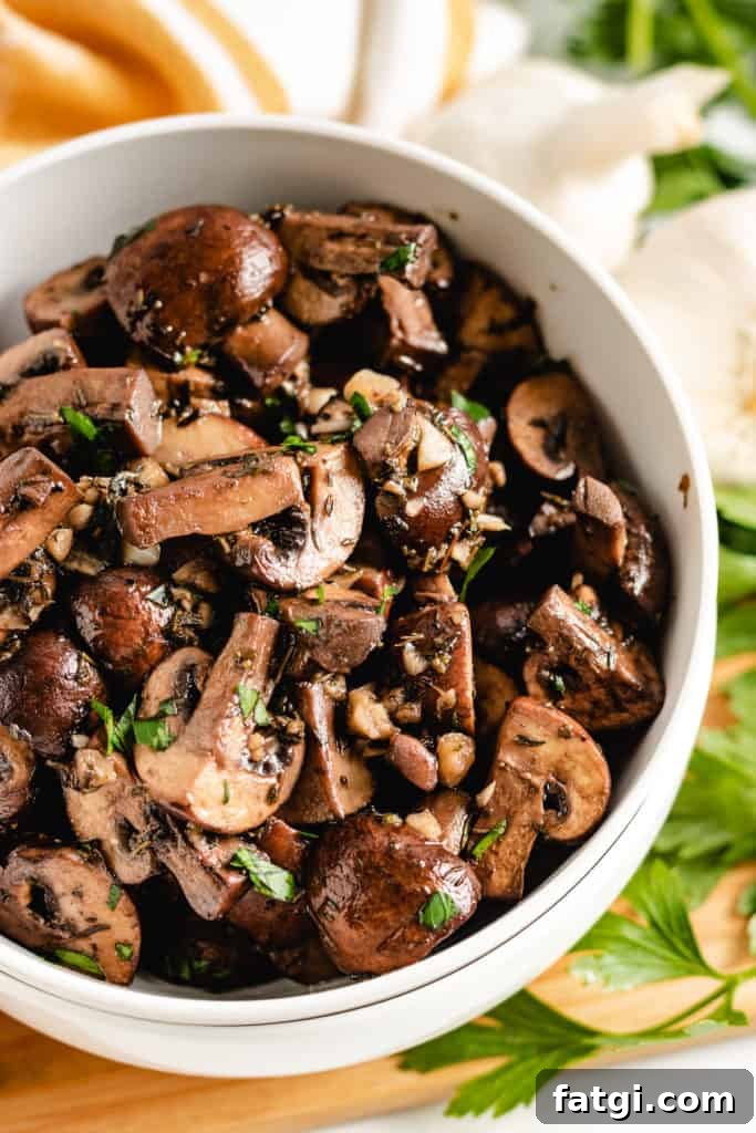 Top down view of sauteed mushrooms in a dish.