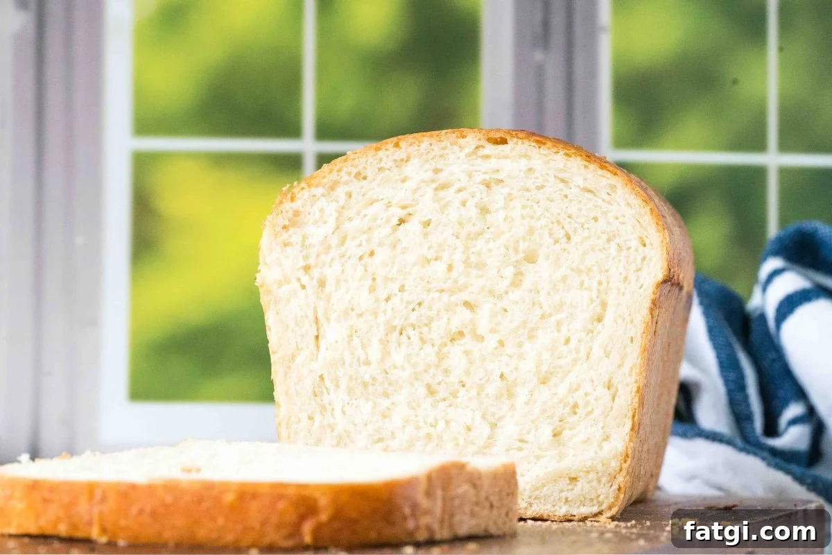 Overnight Sandwich Bread Recipe with Minimal Kneading 9 loaf of bread in front of a window.