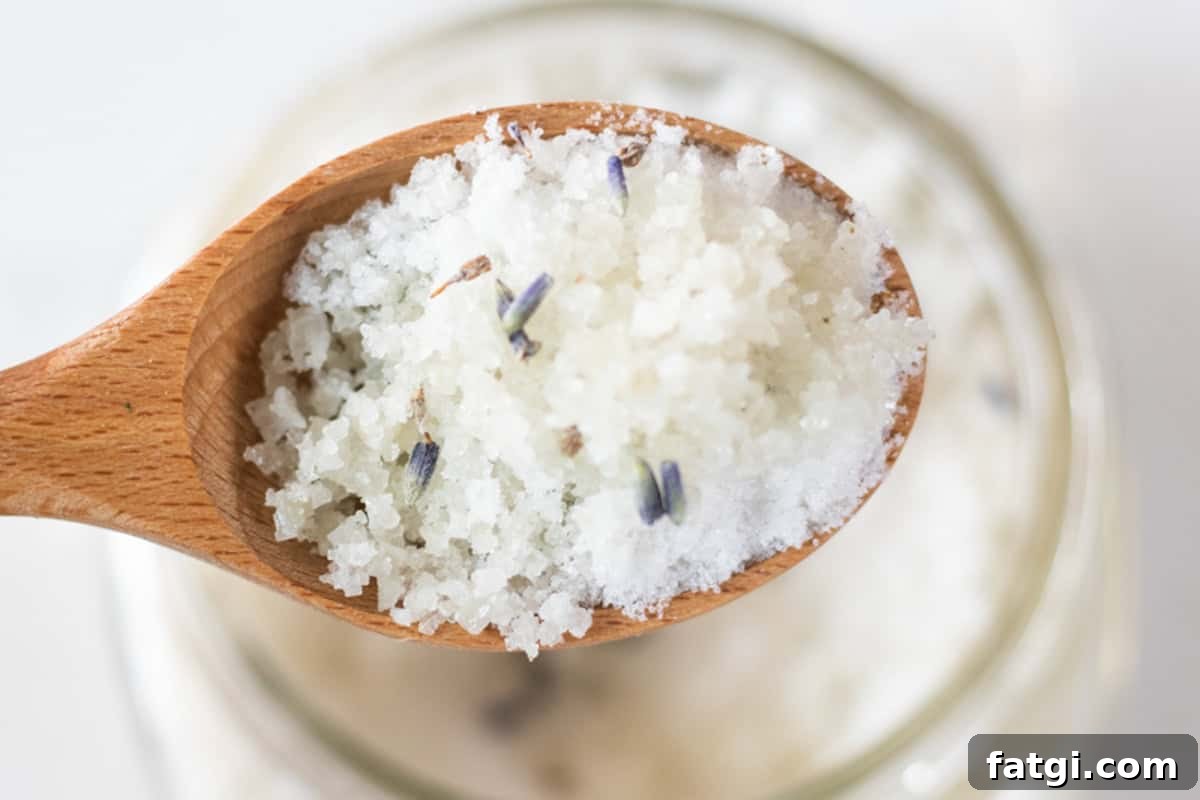 Detox Foot Soak Recipe for Tired Aching Feet 11 A spoonful of detoxifying foot bath being help up over a jar of foot bath.