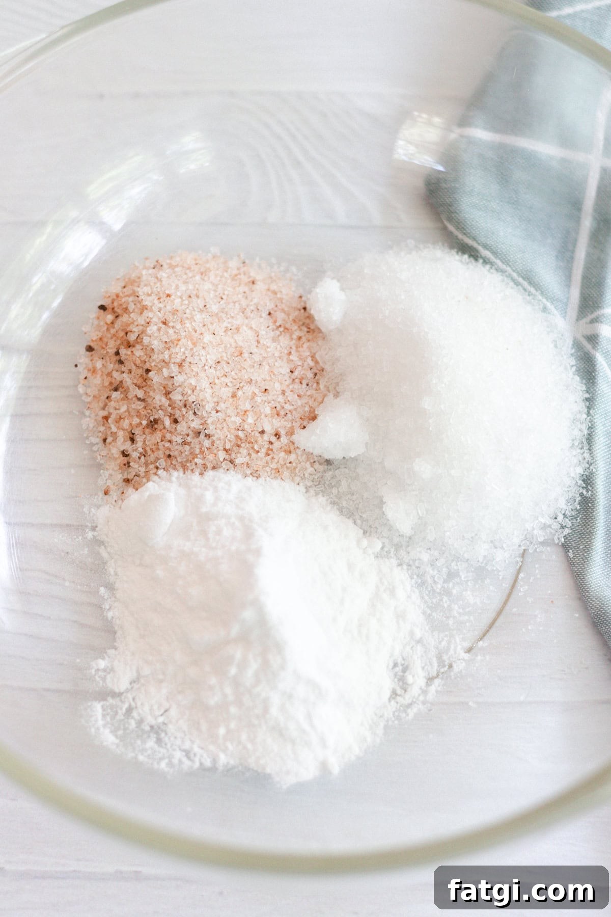 Detox Foot Soak Recipe for Tired Aching Feet 4 Ingredients for a foot bath poured into a glass bowl.