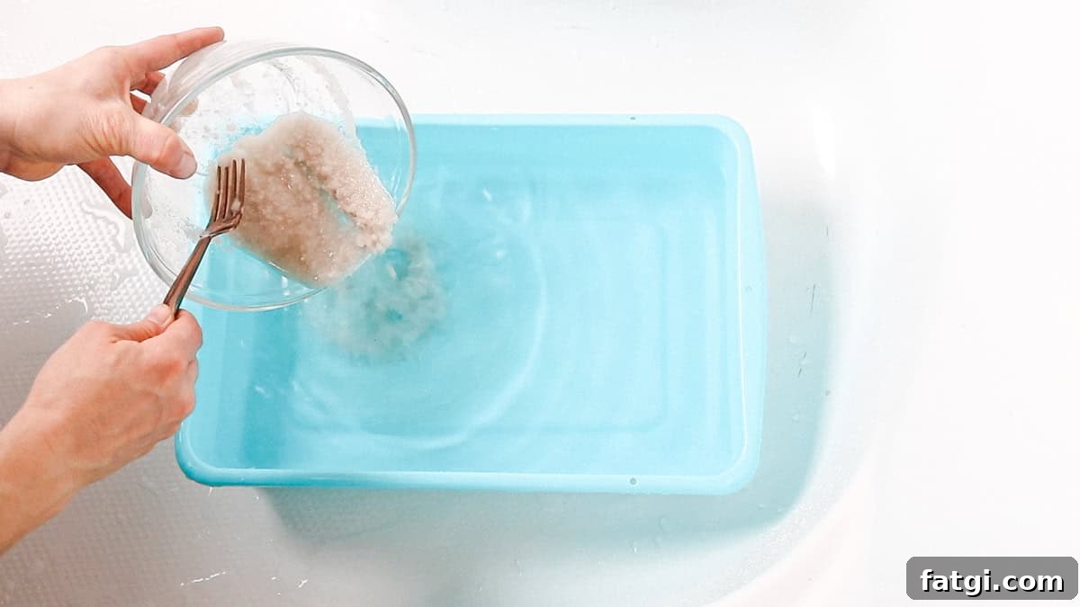 Detox Foot Soak Recipe for Tired Aching Feet 8 Pouring the detox bath salt mixture into a basin with water for a foot bath.