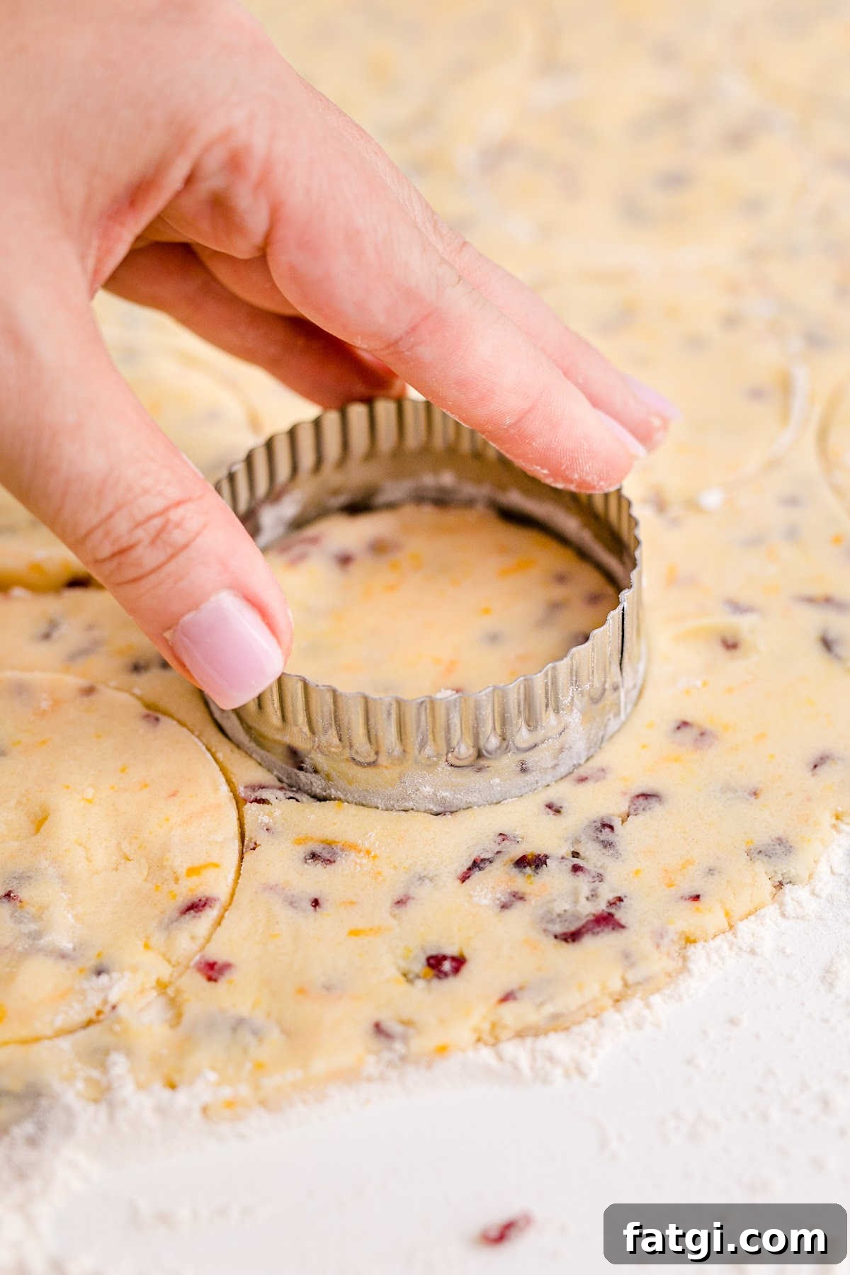 Cookie shapes being cut out of a dough.