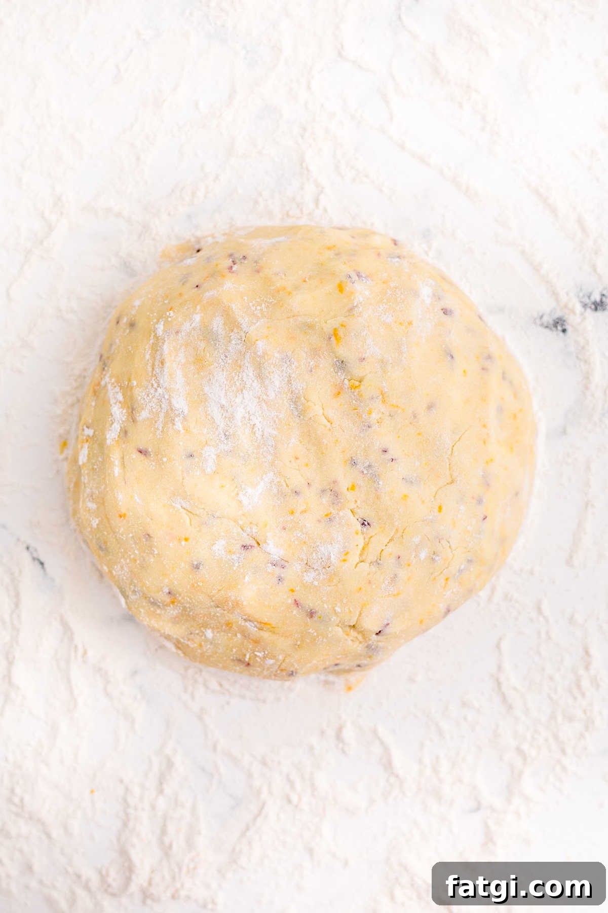 Cookie dough shaped into a disc and wrapped in plastic wrap.