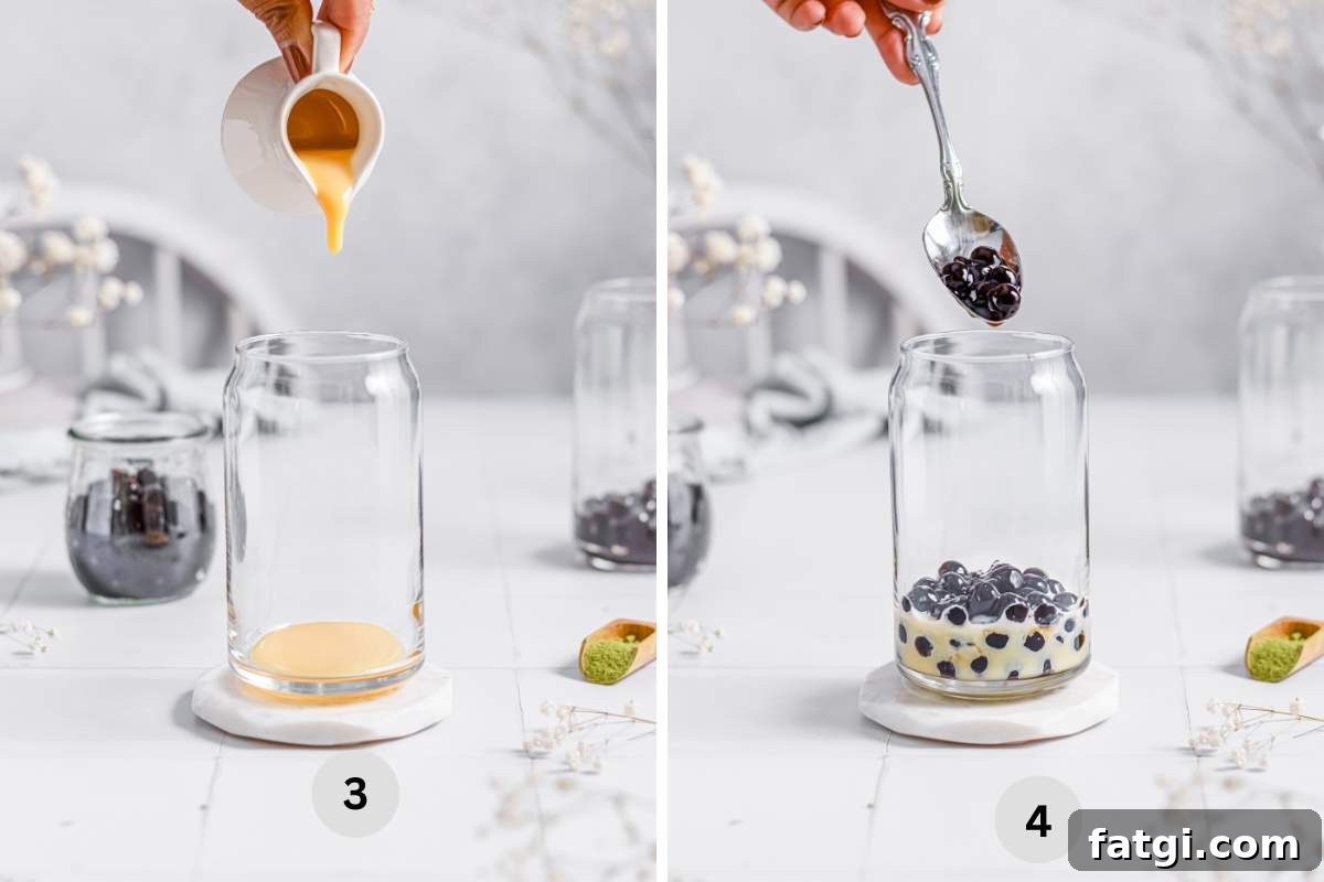 Adding condensed milk and boba pearls in a serving glass.