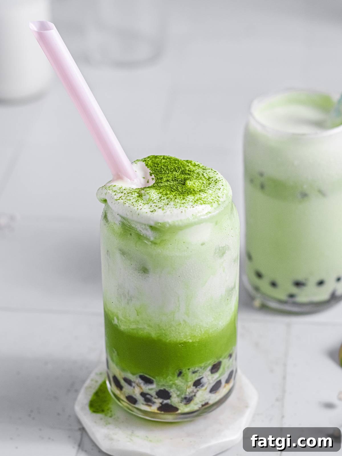 A close up of the green tea topped with frothed milk.