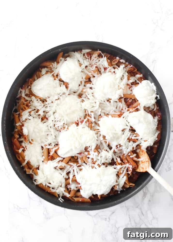 Ricotta and mozzarella added to one-skillet baked ziti before melting