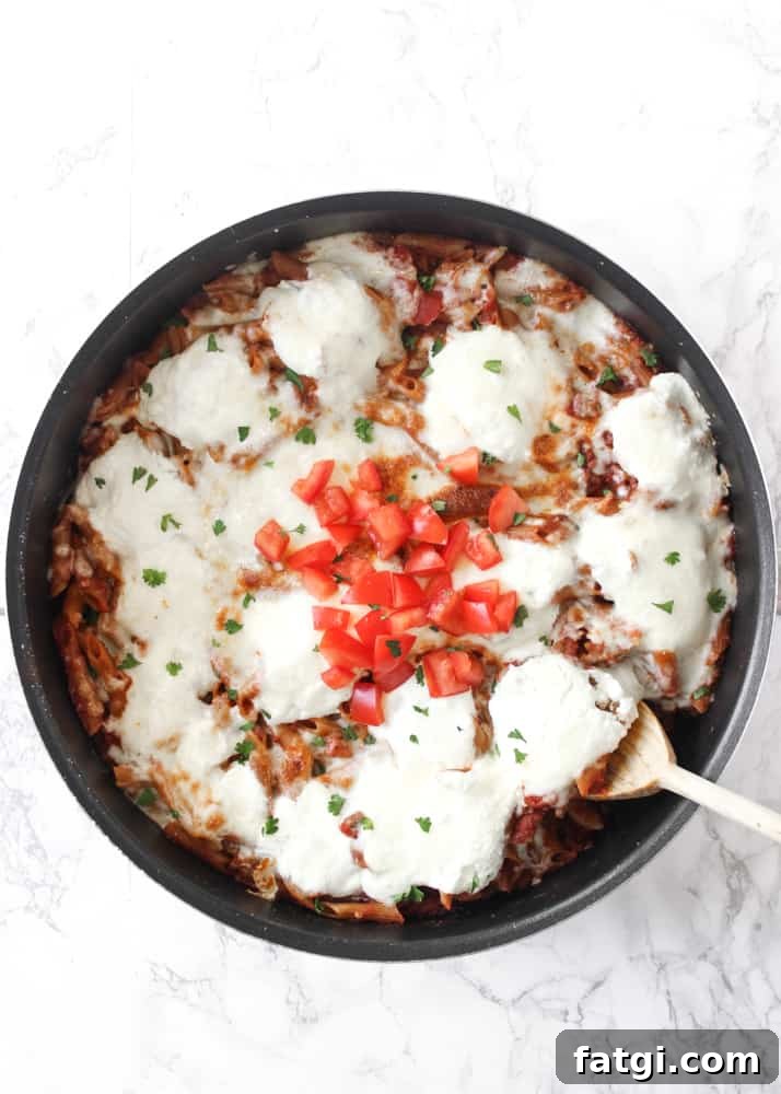 Finished cheesy one-skillet baked ziti with melted mozzarella and ricotta