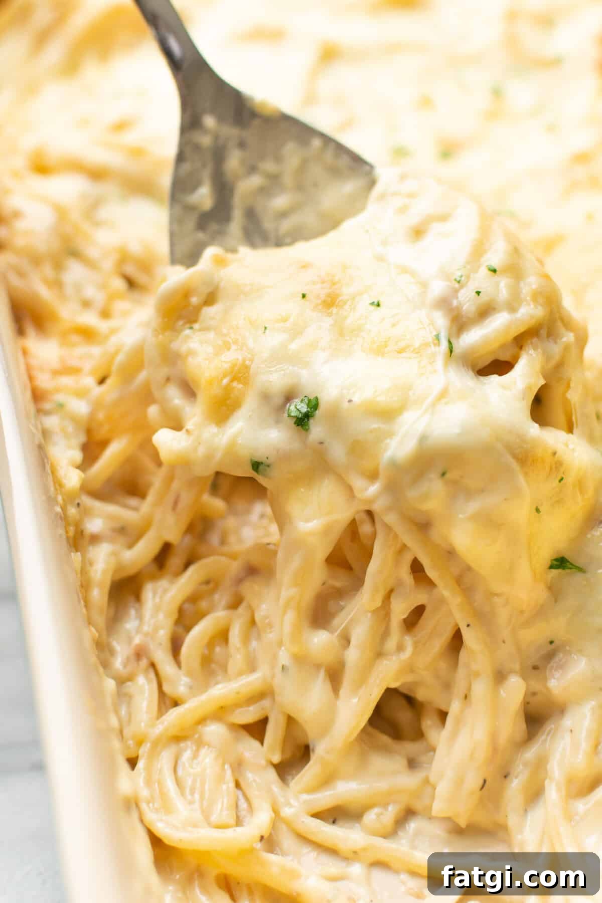 Creamy Ranch Chicken Spaghetti Recipe 2 closeup of a casserole dish with ranch chicken spaghetti and a serving spoon