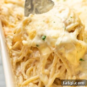 Creamy Ranch Chicken Spaghetti Recipe 7 closeup of a casserole dish with ranch chicken spaghetti and a serving spoon