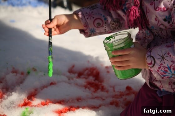 painting the snow with green and red paint