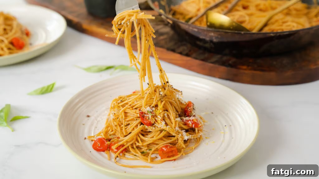 Cherry Tomato Pasta: Quick Flavorful Weeknight Dinner 2 A fork pulling up from a plate of Cherry Tomato Pasta