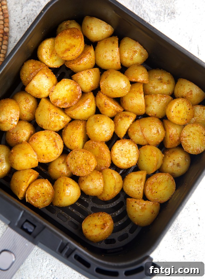 baby potatoes in an air fryer basket before being fried