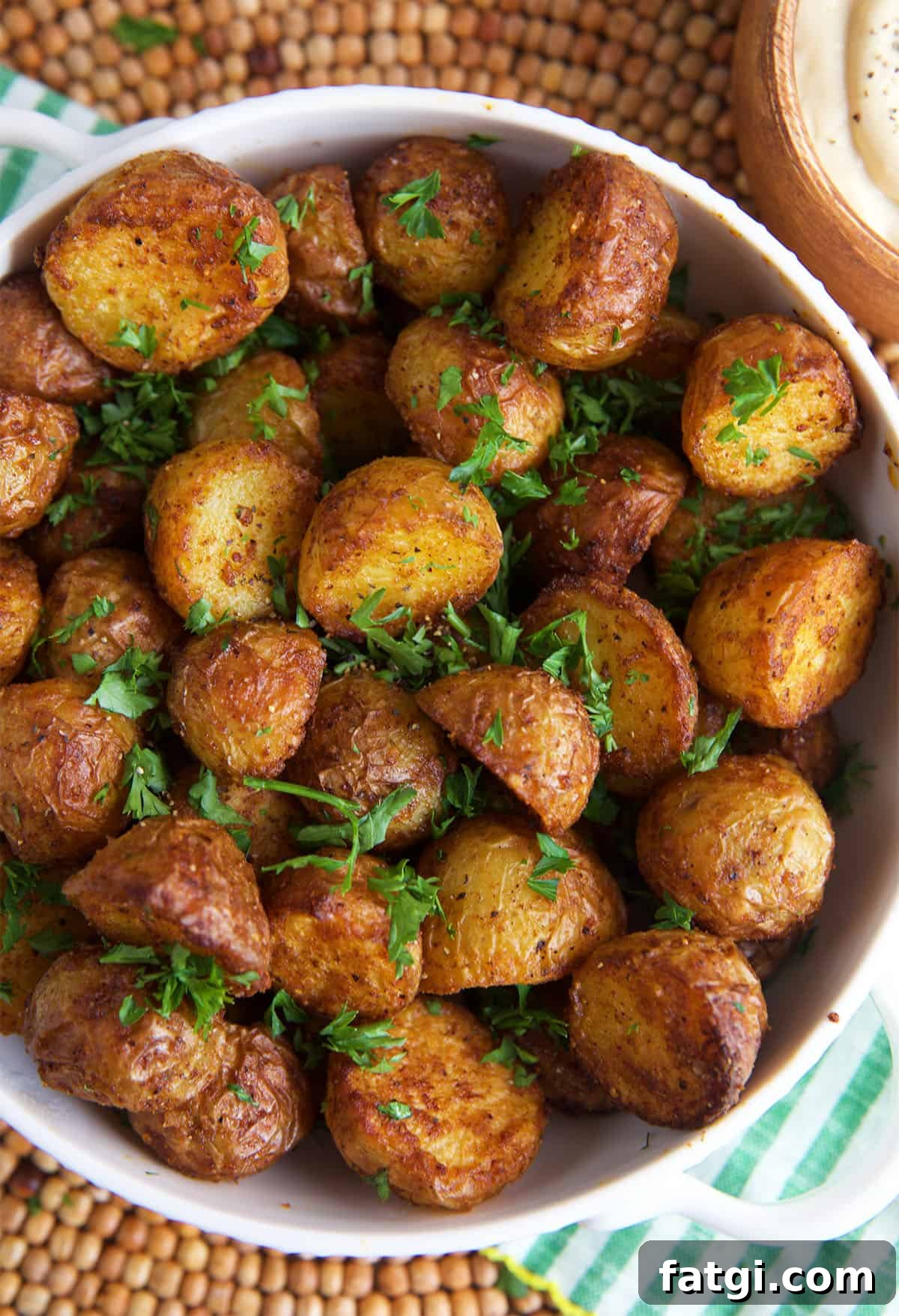 Air Fryer Roasted Potatoes in a white bowl for serving.