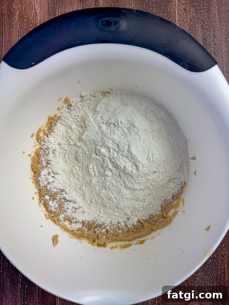 Flour and baking powder added to brown sugar and butter mixture.