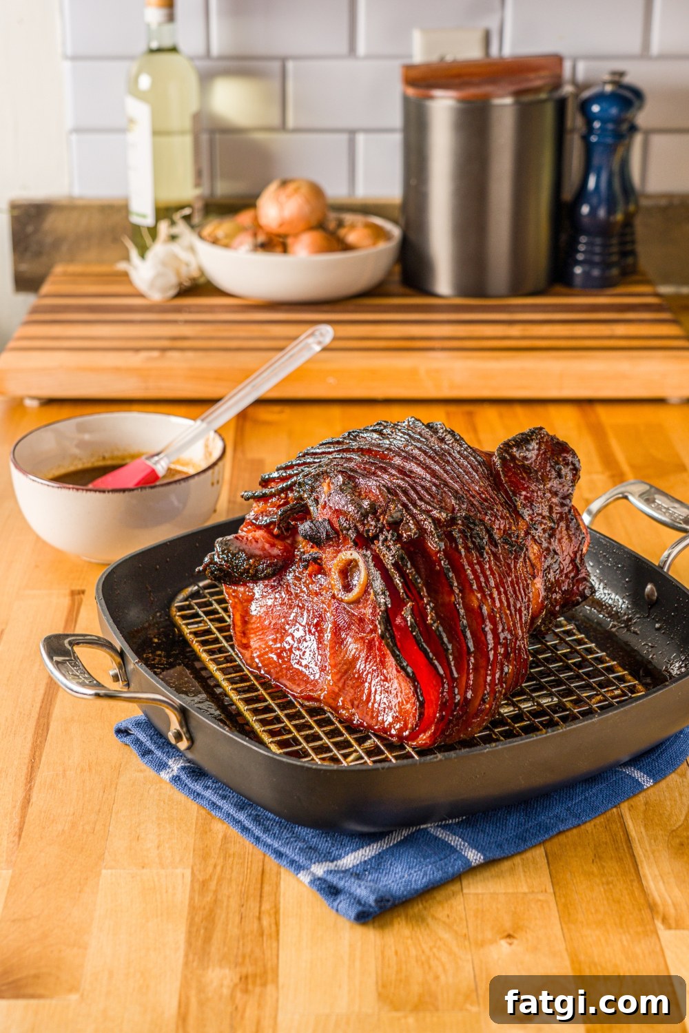 Spiral Ham with Pineapple and Brown Sugar Glaze 11 A baked glazed spiral ham in a roasting pan lined with a rack.