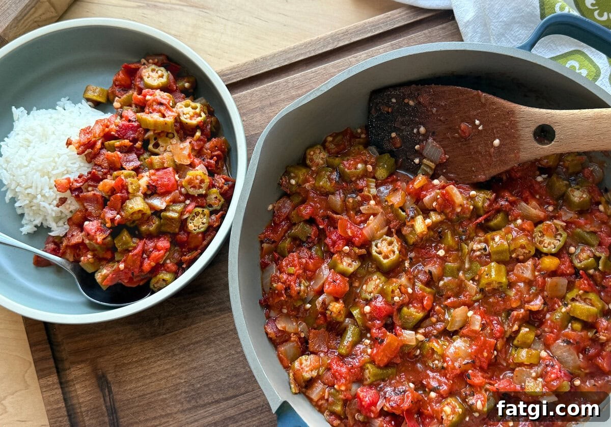 A delicious bowl of vegetable okra stew served alongside fluffy white rice, featuring vibrant tomatoes and tender okra pieces in a rustic setting.