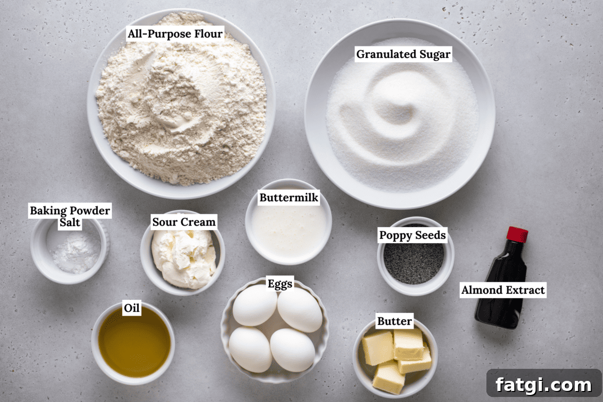 Almond Poppy Seed Muffins Recipe 4 Top-down view of labeled baking ingredients in bowls: all-purpose flour, granulated sugar, baking powder, salt, sour cream, buttermilk, poppy seeds, eggs, almond extract, butter, and oil on a light surface.