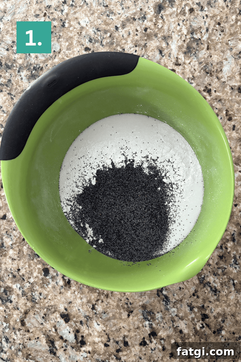 Almond Poppy Seed Muffins Recipe 5 A green mixing bowl with flour and poppy seeds inside sits on a granite countertop.